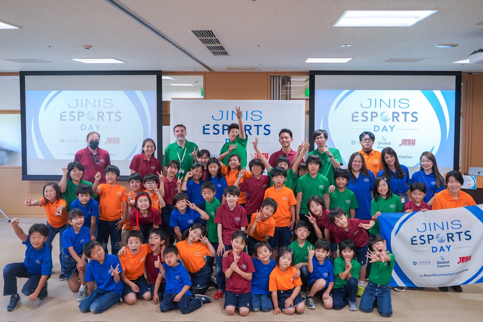 JINIS Esports Day group photo of Jinseki International School students with GAKU and JeSU banners